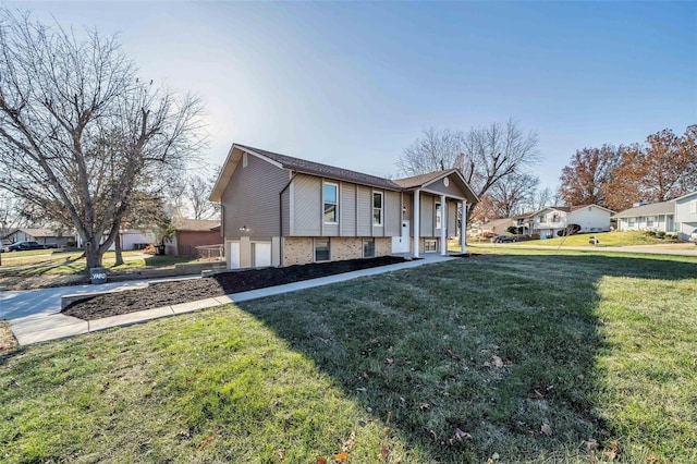 view of side of property featuring a garage and a lawn