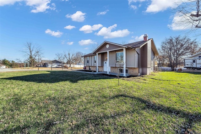 view of side of property with a yard