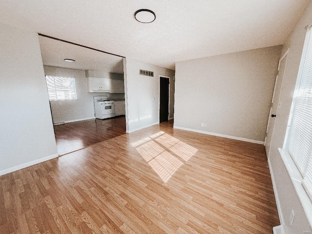 unfurnished living room featuring hardwood / wood-style flooring