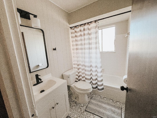 full bathroom featuring wooden walls, shower / tub combo with curtain, vanity, and toilet