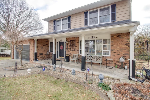 view of front of property featuring covered porch and a garage