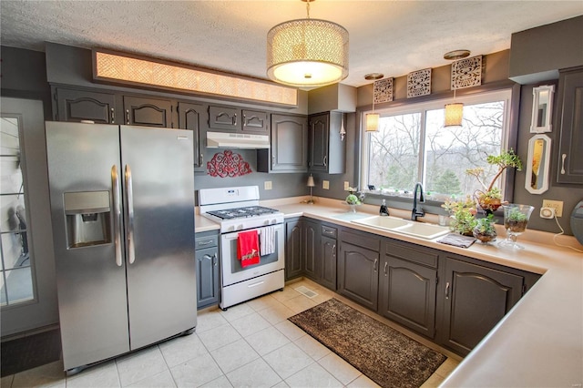 kitchen featuring stainless steel fridge with ice dispenser, gas range gas stove, a textured ceiling, and sink