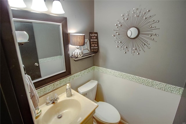 bathroom featuring vanity and toilet