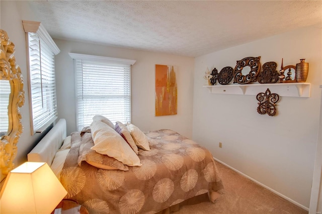 bedroom featuring a textured ceiling and carpet floors