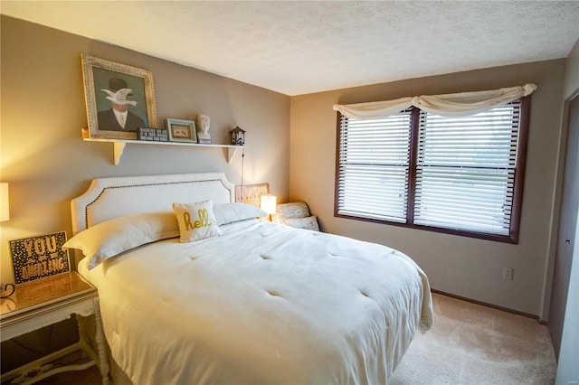 carpeted bedroom featuring a textured ceiling