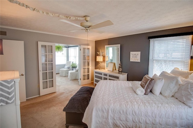 bedroom featuring ceiling fan, french doors, a textured ceiling, light carpet, and ornamental molding