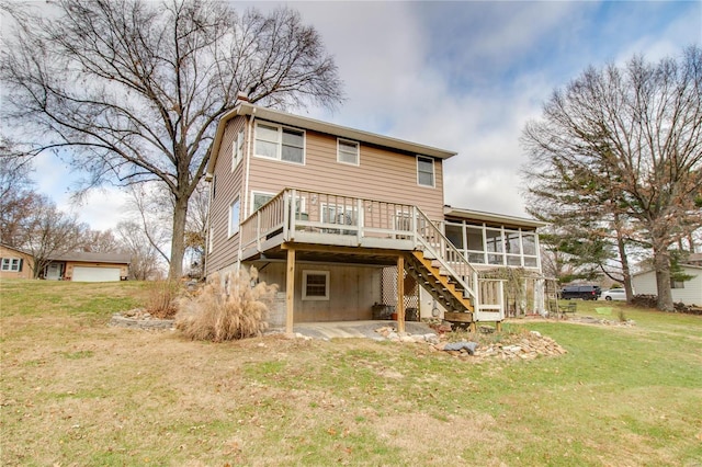 back of property featuring a sunroom, a deck, and a yard