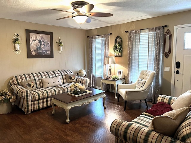 living room featuring a textured ceiling, dark hardwood / wood-style flooring, and ceiling fan