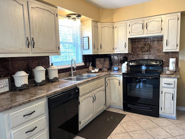 kitchen with backsplash, sink, light tile patterned flooring, and black appliances