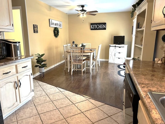 dining area featuring light wood-type flooring, ceiling fan, and sink