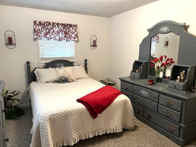 bedroom featuring carpet floors and a textured ceiling