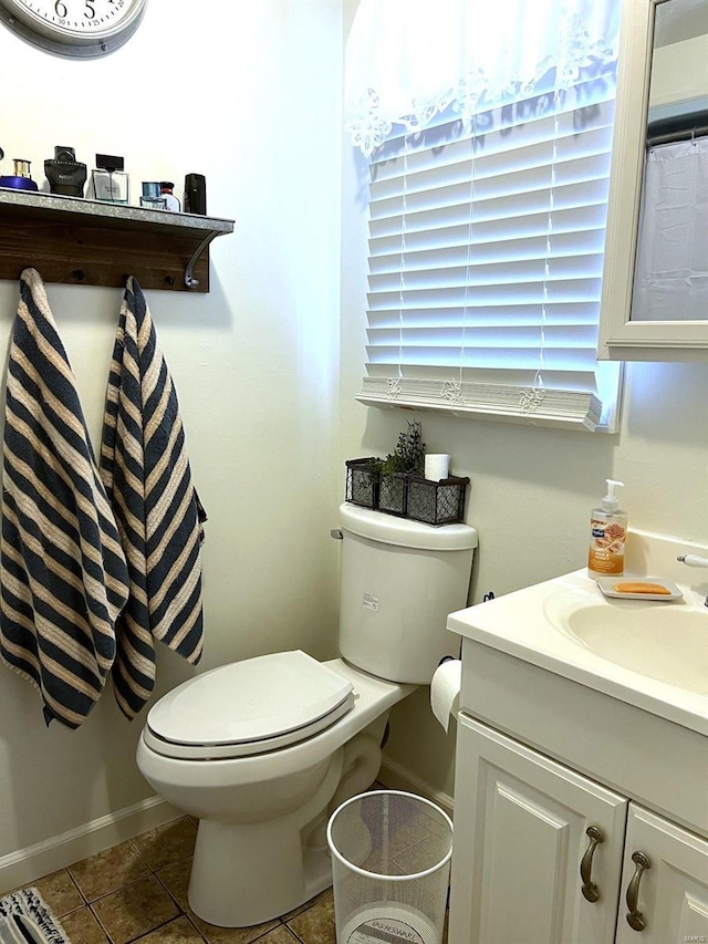 bathroom featuring tile patterned flooring, vanity, and toilet