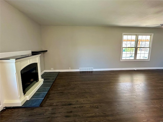 unfurnished living room featuring dark wood-type flooring