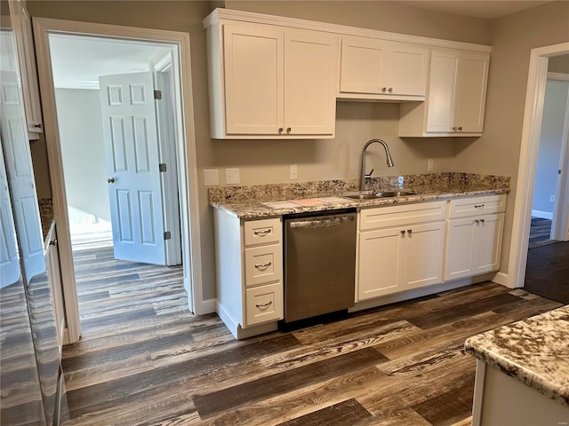 kitchen with white cabinetry, sink, light stone counters, and stainless steel dishwasher