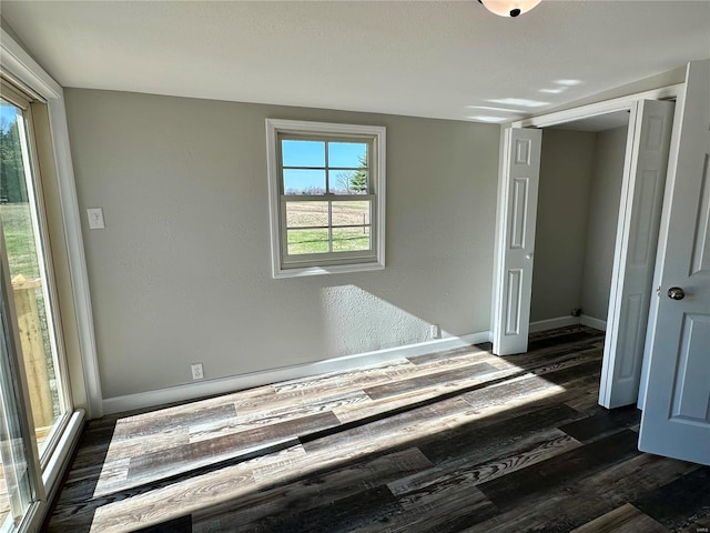 unfurnished bedroom featuring dark wood-type flooring