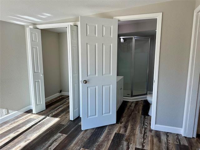 interior space featuring hardwood / wood-style flooring, toilet, and walk in shower