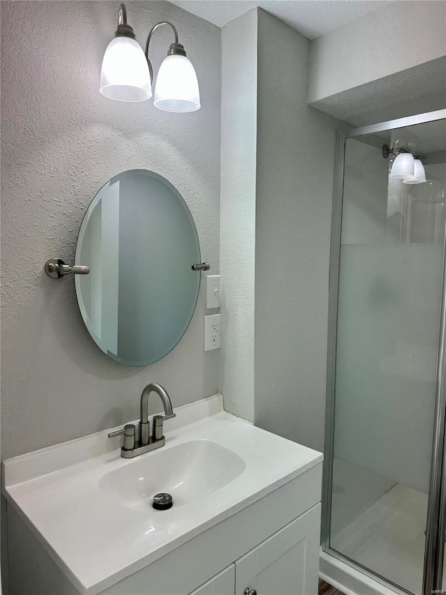 bathroom with vanity and an enclosed shower