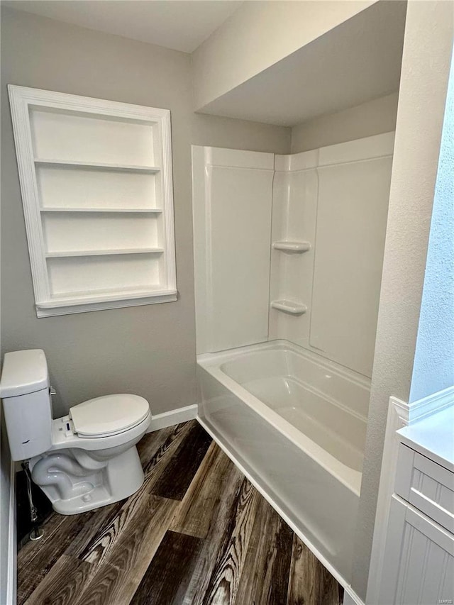 full bathroom with vanity, hardwood / wood-style flooring,  shower combination, and toilet