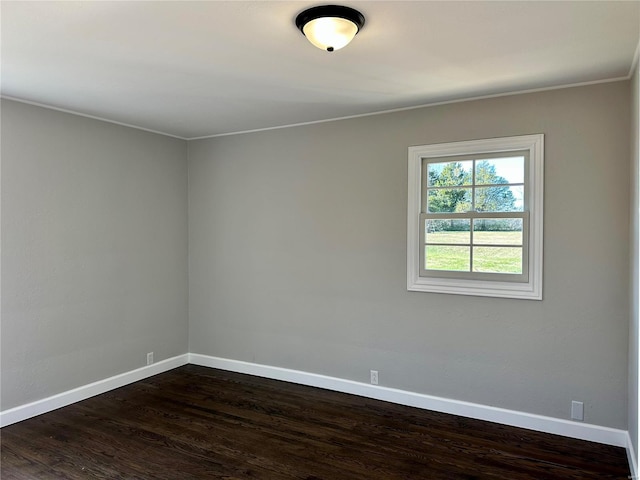 spare room with dark wood-type flooring