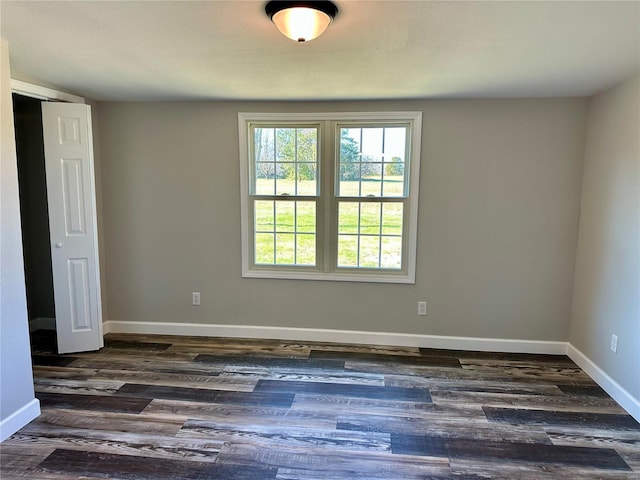 spare room featuring dark wood-type flooring