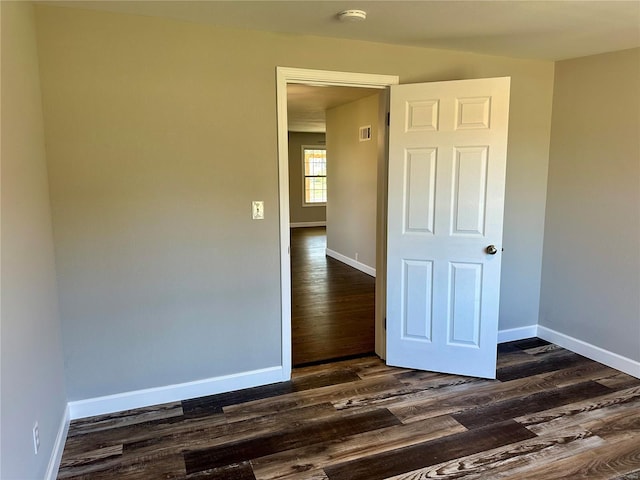 unfurnished room with dark hardwood / wood-style floors