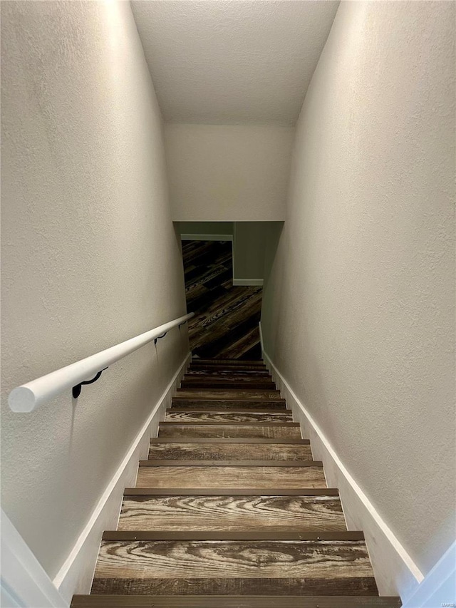 staircase featuring hardwood / wood-style flooring