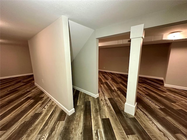 hallway featuring dark hardwood / wood-style flooring and a textured ceiling