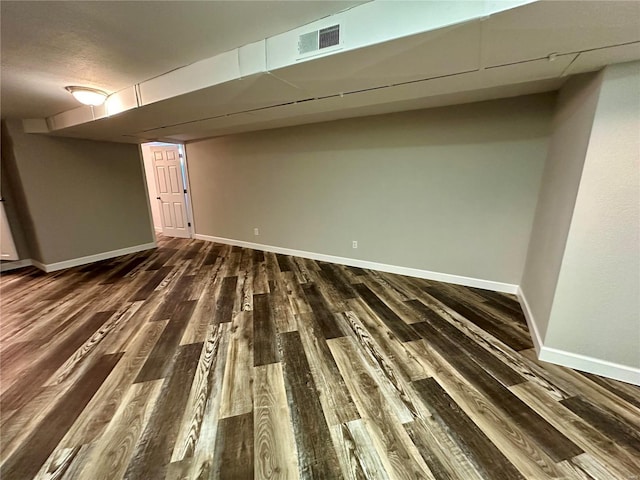 basement featuring dark hardwood / wood-style floors