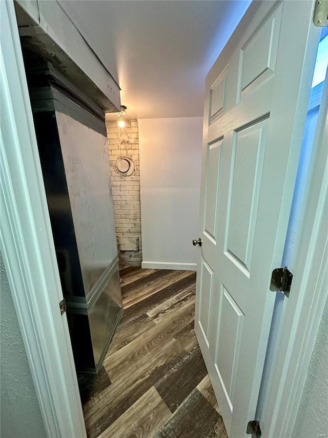 corridor with dark hardwood / wood-style flooring