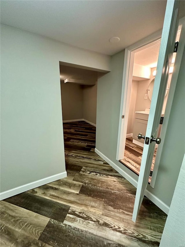 hallway with dark hardwood / wood-style flooring