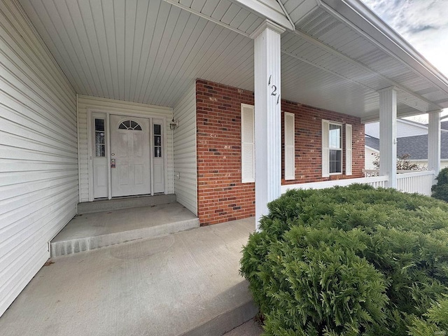 view of exterior entry featuring a porch