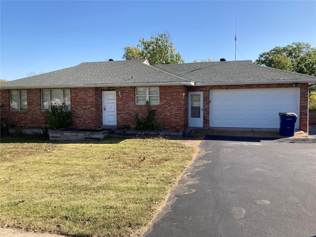 ranch-style home with a front lawn and a garage