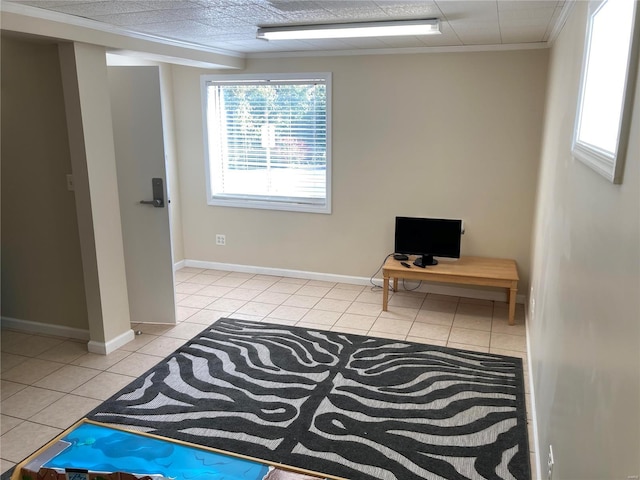 interior space featuring crown molding and light tile patterned floors