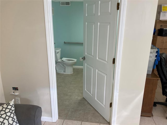 bathroom with tile patterned floors and toilet