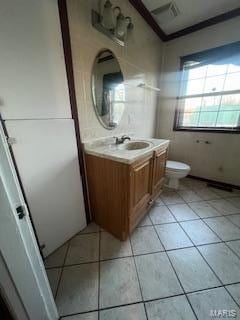 bathroom with tile patterned flooring, vanity, and toilet