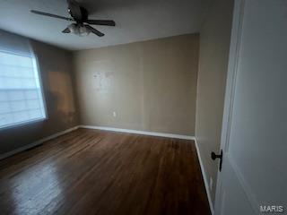 unfurnished room with dark hardwood / wood-style floors and ceiling fan