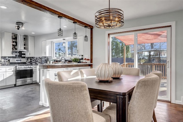 dining area with wood-type flooring and an inviting chandelier