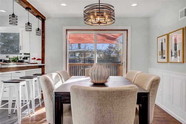 dining space featuring hardwood / wood-style floors and a notable chandelier