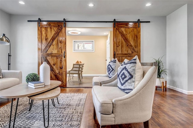 living room with hardwood / wood-style floors and a barn door