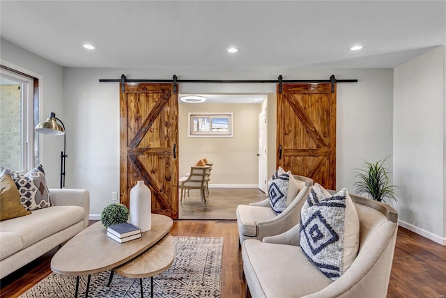 living room with hardwood / wood-style floors and a barn door