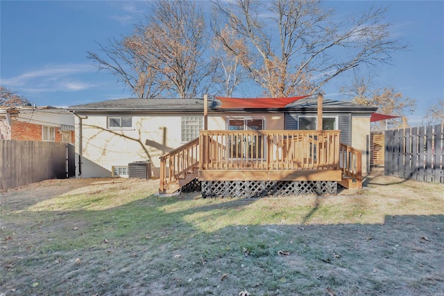 rear view of property featuring central AC unit, a deck, and a yard