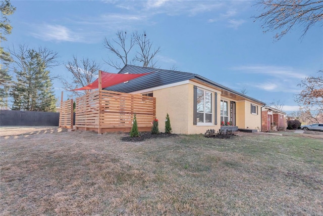 view of side of property with a yard