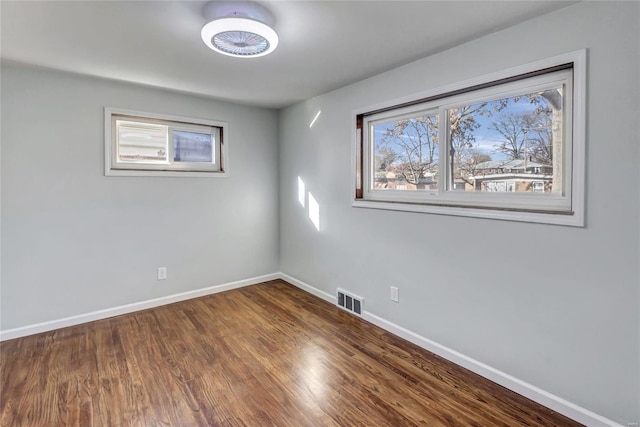 unfurnished room with wood-type flooring