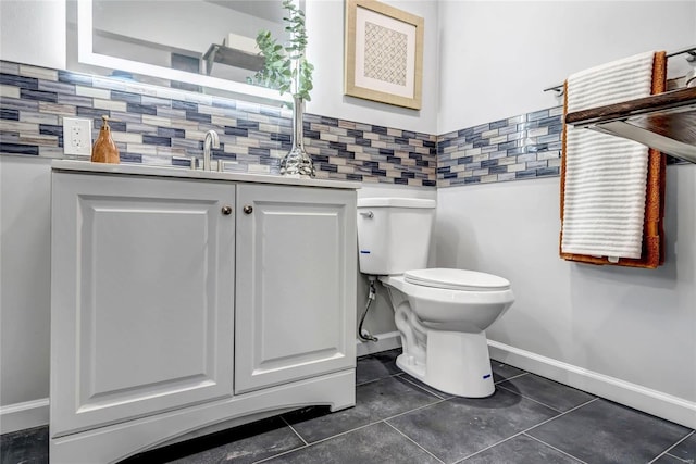 bathroom with tile patterned floors, vanity, toilet, and backsplash