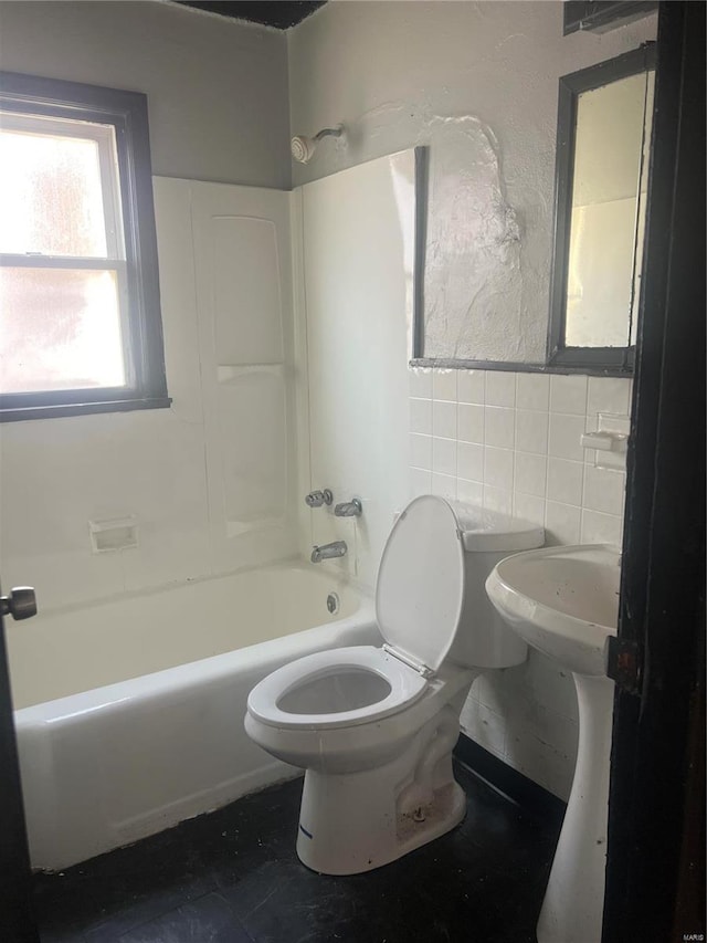 bathroom with tile patterned flooring,  shower combination, toilet, and tile walls