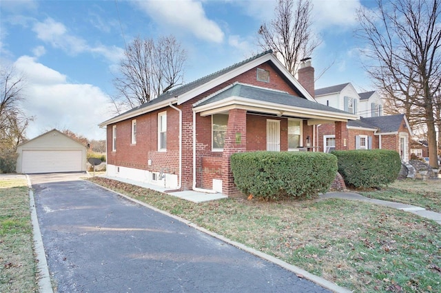 view of front of home with covered porch, a garage, and an outdoor structure