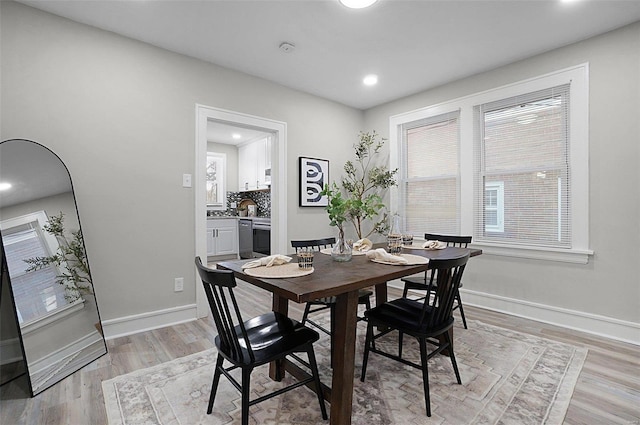 dining space with light hardwood / wood-style floors