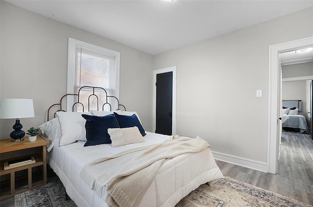 bedroom with dark hardwood / wood-style flooring