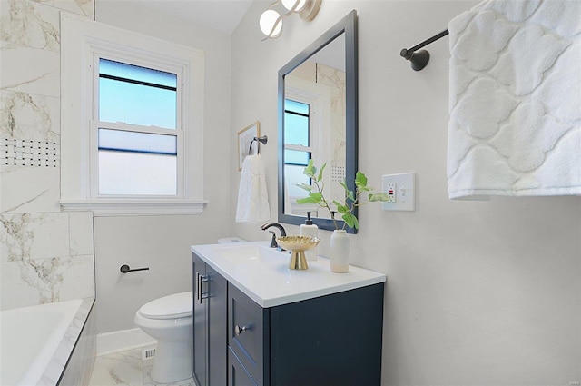 bathroom featuring vanity, toilet, and a bathtub