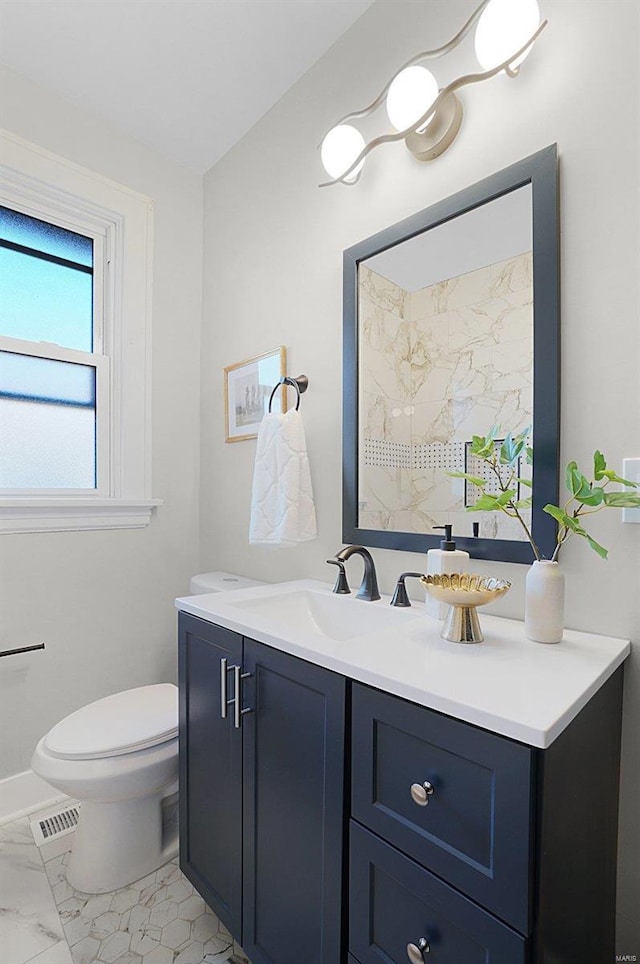 bathroom featuring vanity and toilet